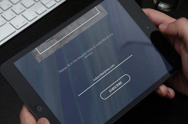 Tablet with an email subscription registration popup on the screen.